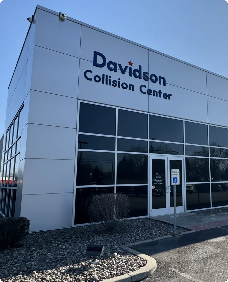Exterior View Of Davidson Collision Center Building With Large Windows And Signage.